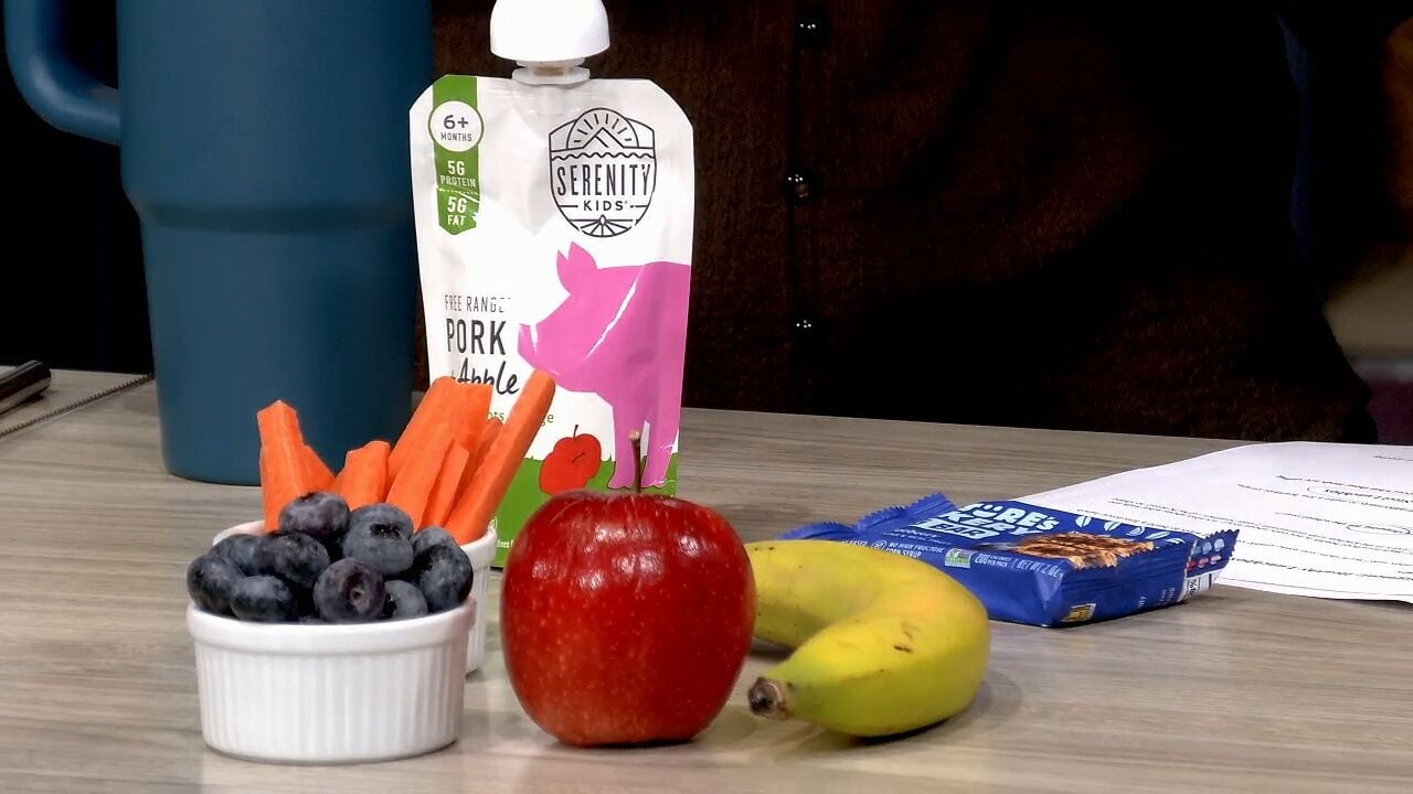 A healthy school lunch with fresh fruit, carrots, a reusable water bottle, and snack items on the WFMZ Sunrise set